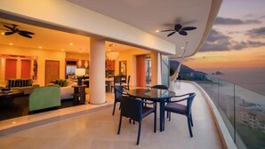 A modern interior with a dining area, seating, and a balcony with a view. - Garza Blanca Preserve Resort & Spa (Puerto Vallarta)