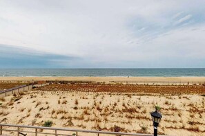 A beach view with a fence, a lamp post, and the ocean in the background. - Town of Bethany Beach Condo Steps To Ocean w/Free WiFi, Private Washer/Dryer (Bethany Beach)