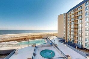A hotel with a rooftop pool overlooking the beach, a multi-story building with balconies, and a clear view of the ocean. - Entire condo in Bethany Beach, Delaware (Bethany Beach)
