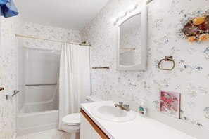 A bathroom with a shower, toilet, sink, and mirror. - Bethany Pines Townhouse w/Free WiFi, Private Washer and Dryer, & Shared Pool (Bethany Beach)