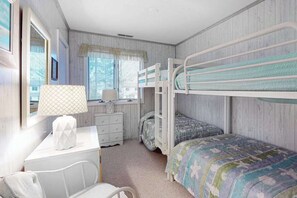 A bunk bed room with a desk, chair, and dresser. - Bethany Pines Townhouse w/Free WiFi, Private Washer and Dryer, & Shared Pool (Bethany Beach)