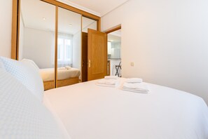 A hotel room with a bed, a wardrobe, and a kitchenette area. - (VAL203E) 1 bedroom apartment in the center of Madrid (Madrid)