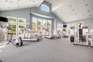 A gym with treadmills, elliptical machines, and weight equipment. - Bayside Bethany Lakes retreat with pool access, screened patio & fast WiFi (Ocean View)