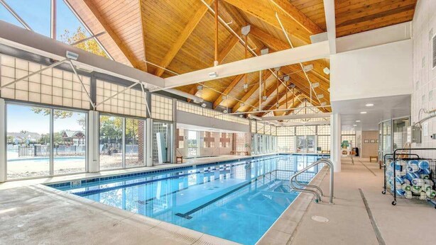 An indoor swimming pool with a high ceiling, large windows, and a visible lifeguard station. - Bear Trap Dunes Townhouse Near Bethany Beach w/Shared Pool, Free WiFi, W/D (Ocean View)
