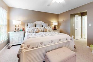 A bedroom with a bed, bedside tables, a nightstand, a window, and a door. - Lord Baltimore Landing house w/shared pool, free WiFi, central AC, private W/D (Ocean View)