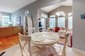 A dining area with a round table, chairs, and a ceiling fan. - Lord Baltimore Landing house w/shared pool, free WiFi, central AC, private W/D (Ocean View)