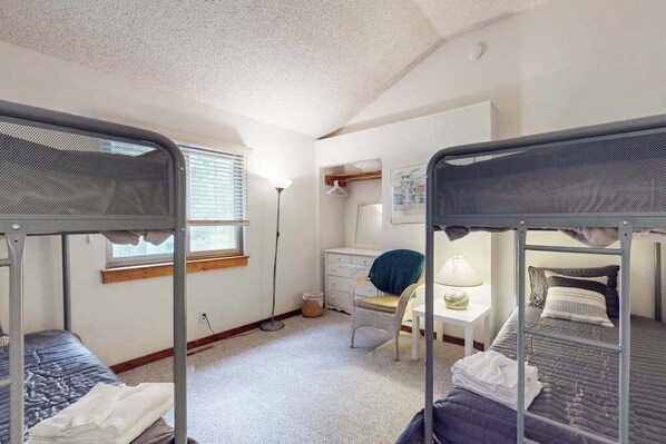A dormitory room with bunk beds, a desk, a chair, and a lamp. - Relaxing South Bethany beach retreat, access to private beach and screened porch (South Bethany)