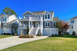 A multi-story residential building with a central staircase, a covered front porch, and a driveway. - Resort Living in Bethany. AC/Pool and more. (Bethany Beach)