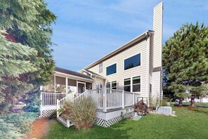 A two-story house with a front porch and a small deck. - Wedgefield House in Ocean View w/Private Washer/Dryer, Free WiFi, Shared Pool (Ocean View)