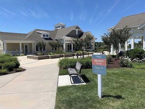 A residential area with a sign for 'Millville Beach Shuttle Stop #1'. - Millville by the Sea townhome with clubhouse, pools & wellness center access (Millville)
