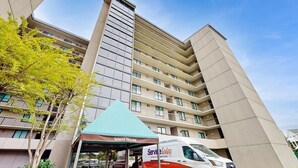 A multi-story building with a service van parked in front. - Sea Colony 2nd floor oceanside condo w/community pools, tennis, fitness center (Bethany Beach)
