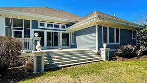 A two-story house with a front porch, a covered entryway, and a small front yard. - Bethany Bay house w/community pool, hot tub, tennis, on-site golf (Ocean View)