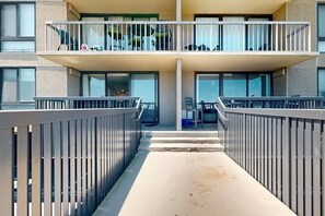 A modern hotel with a central courtyard, balconies, and a view of the surrounding area. - Sea Colony Ocean 1st floor condo w/ elevator, tennis court, and basketball court (Bethany Beach)