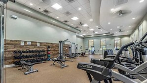 A gym with treadmills, dumbbells, and weight machines. - Ocean View Beach Club townhome with WiFi, private patio, shared pool, & sauna (Ocean View)