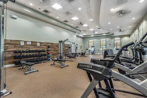 A gym with treadmills, dumbbells, and weight machines. - Ocean View Beach Club townhome with WiFi, private patio, shared pool, & sauna (Ocean View)