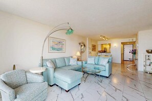 A living room with a sectional sofa, a round coffee table, and a floor lamp. - Oceanfront complex with beach access & charm - pools, tennis, fitness centers (Bethany Beach)