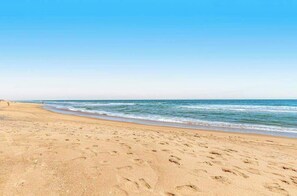 A beach with footprints in the sand and a clear blue sky. - Oceanfront complex with beach access & charm - pools, tennis, fitness centers (Bethany Beach)