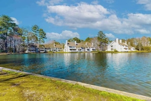 A lakeside view of a residential area with houses and a clear sky. - Sea Colony - 33577 West Lake View, Unit 1006B | Condo in Bethany Beach (Bethany Beach)