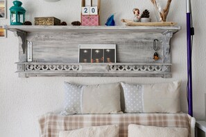 A rustic wooden shelf with decorative items, a thermometer, and framed photos. - Studio on La Corniche with Shared Pool, Private Terrace, and Shared Garden (Saint-Palais-sur-Mer)
