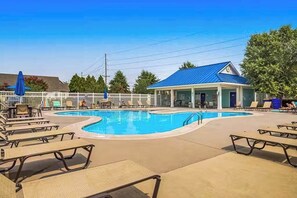 A pool area with lounge chairs, a small building with a blue roof, and a white fence. - Newly remodeled - dog friendly townhome with pools, tennis, washer/dryer & AC (Millville)