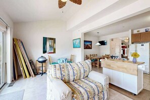 A spacious living area with a sofa, dining table, and kitchen area. - South Hampton 3-level spacious home with shared pool, balcony & free WIFI (Ocean View)