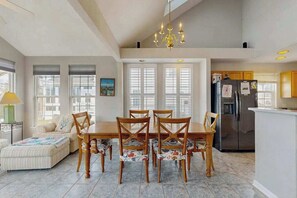 A spacious kitchen with a dining area, large windows, and a chandelier. - South Hampton house with shared community pool & tennis courts (Ocean View)