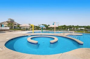A swimming pool with a circular design, a lifeguard stand, and a pavilion. - Millville By The Sea - 36692 Calm Water Dr | Townhouse in Millville (Millville)