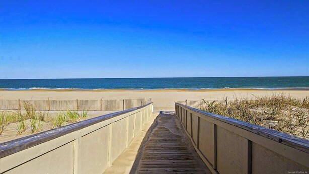 A wooden boardwalk leading to a beach with a clear blue sky. - Kings Grant Beachfront Townhouse w/Ocean Views, Shared Pool, Free WiFi, Private (Fenwick Island)