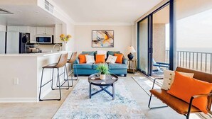 A modern apartment with a kitchen, living area, and balcony. - Enjoy views, resort amenities & a spacious condo for perfect beach retreat (Bethany Beach)