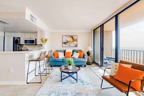 A modern apartment with a kitchen, living area, and balcony. - Enjoy views, resort amenities & a spacious condo for perfect beach retreat (Bethany Beach)