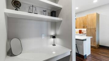 A modern kitchen with wooden cabinets, a white countertop, and a small island.