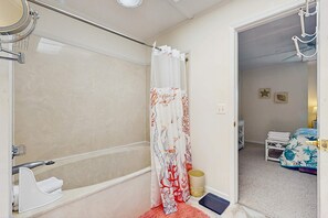 A bathroom with a shower, a toilet, a sink, and a mirror. - Mallard Lakes condo w/community pool, hot tub, tennis & basketball court (Selbyville)
