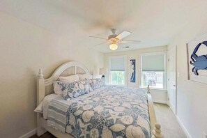 A bedroom with a bed, a ceiling fan, and a window. - Bayside Resort townhouse w/community pools, hot tubs, tennis & on-site golf (Selbyville)