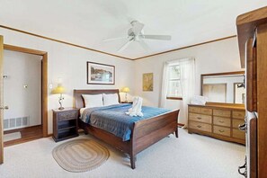 A bedroom with a bed, bedside lamps, a ceiling fan, a dresser, and a mirror. - South Bethany Canal Front home, dock, deck, grill (Bethany Beach)