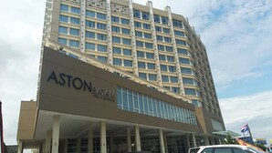 A multi-story hotel building with a prominent 'ASTONBATAM' sign on the lower facade.