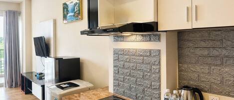 A modern kitchen with a built-in stove, a coffee maker, and a water dispenser.