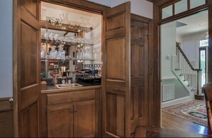 A wooden interior with a kitchen area, a staircase, and a patterned rug. - Relaxing Masters Week Getaway Near Savannah River & Evans 20 Min to the National (Evans)