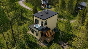 A modern two-story cabin with a rooftop pool, surrounded by dense forest. - Spa & Nature Escape | Le Nova (Adstock)