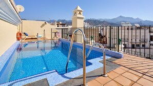 A rooftop pool with a clear view of mountains, a lifeguard chair, and a small tower structure. - Apartment '1D - 2 bedrooms 4-6 people' with shared pool, Wi-Fi and air conditioning (Nerja)