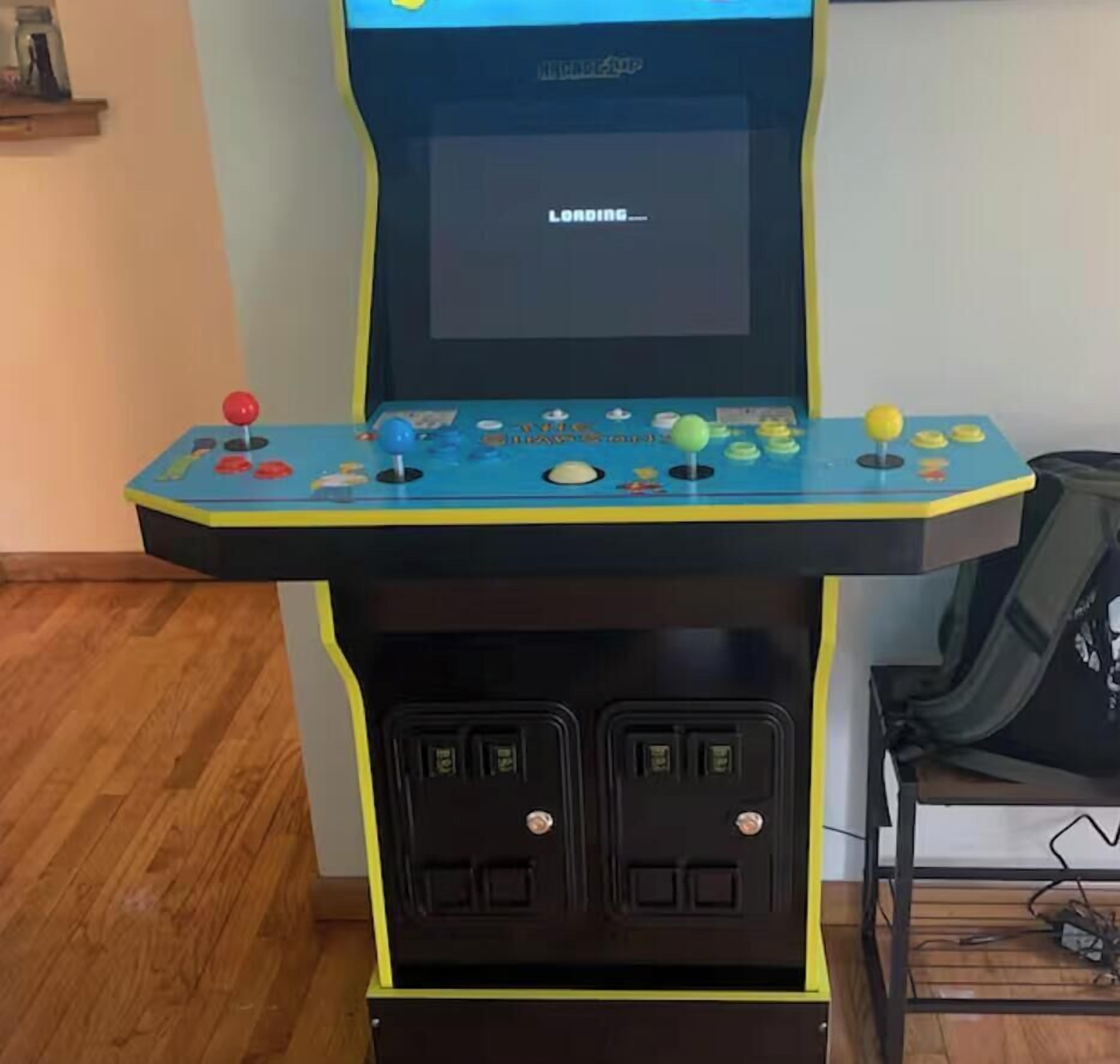 A video game arcade machine with a screen, joystick, buttons, and two control panels.