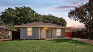 A single-story house with a front door, two windows, and a small front yard. - Serene Escape - Peaceful 3-bd Retreat With Yard (Grand Prairie)