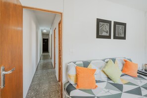 A room with a bed, a wooden door, a hallway, and two zebra-themed wall art pieces. - Vacation Home 'Pisito De Pueblo II' with Mountain View, Wi-Fi, and Air Conditioning (Navaluenga)