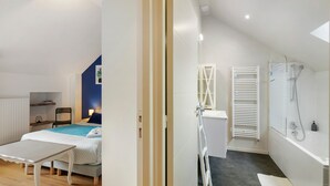 A bedroom with a bed, bedside table, and a chair.