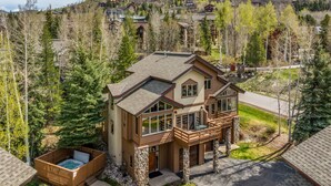 A two-story house with a balcony and a hot tub. - Great Savings for Labor Day! A/C, Hot Tub, 2 En suites (Steamboat Springs)