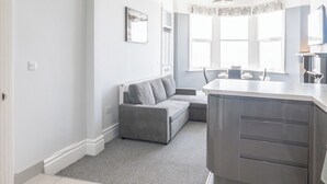 A modern kitchen with a grey countertop and a built-in oven. - Cosy 2-Bed apartment | sleeps 6 | Sea views - Pass the Keys (Southend-on-Sea)