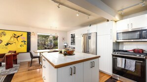 A modern kitchen with white cabinets, stainless steel appliances, and a central island. - Woodstock Waterfall Hideaway · Walk To Tinker St! (Woodstock)