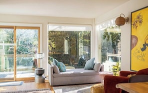A modern living room with a sofa, a table, and a lamp.