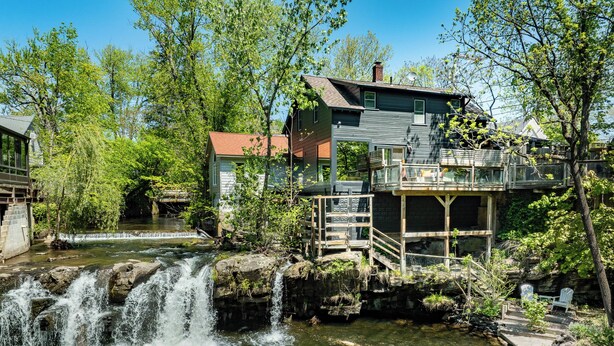 A house with a waterfall, a dock, and a bridge. - Woodstock Waterfall Hideaway · Walk To Tinker St! (Woodstock)