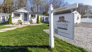 A cottage street inn sign with a house and trees in the background. - Downtown Ogunquit!  Steps to the Beach, Dining & Shops! Park & Walk Everywhere! (Ogunquit)