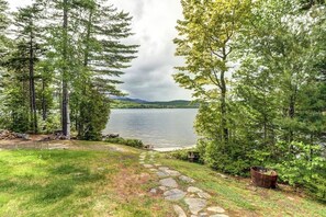 A natural landscape with a lake, trees, and a stone pathway. - Lakefront Cabin with Lake Views, Private Dock & Entertainment - Great for Families (Greenville)